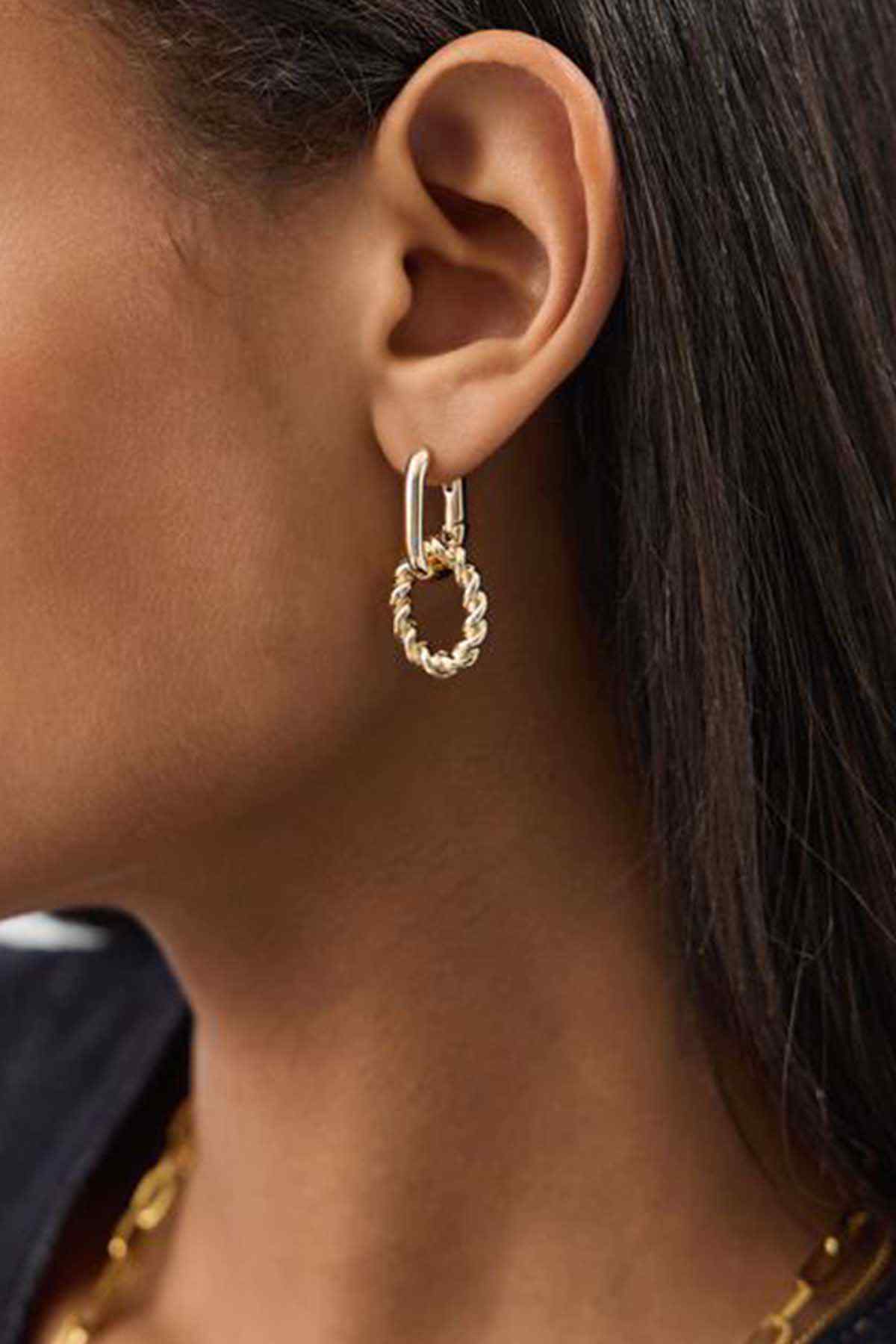 Accessorize gold hoop earrings with dangling chain links and charm