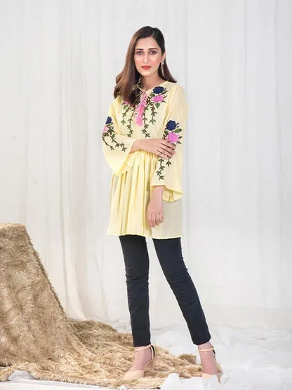 Women’s yellow gathered tunic with pink and navy floral embroidery at neckline
