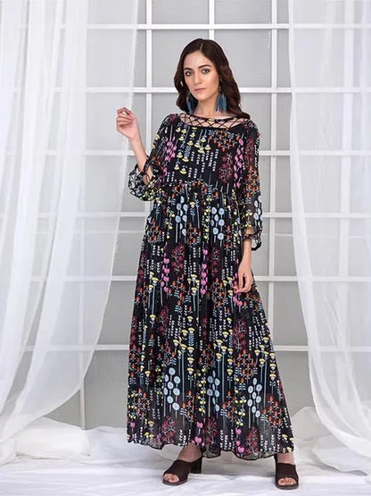 Long-sleeve printed maxi dress with colorful scattered motifs and soft gathered skirt
