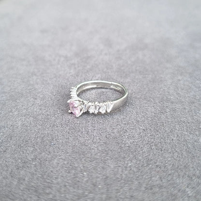 Silver-tone ring with light pink center gemstone and white fringe detailing