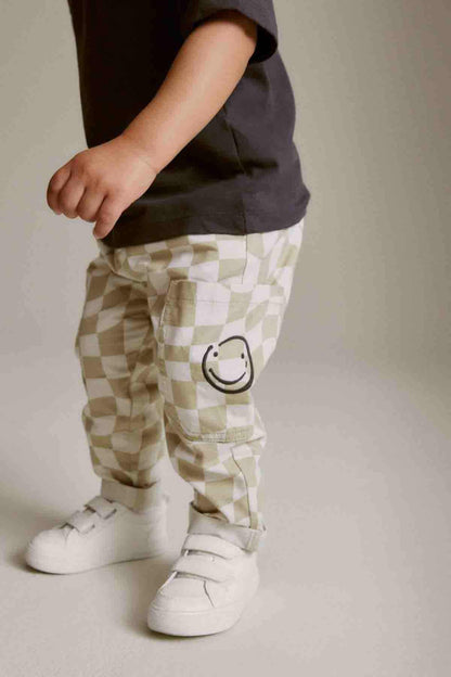 NEXT checked trousers with smiley patch, white sneakers