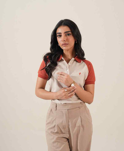 Fitted polo shirt with red sleeves and collar, small chest logo; khaki pants