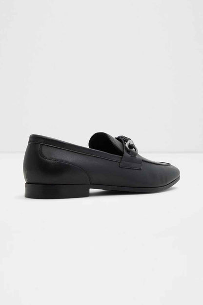 Black leather loafer, angled view showing slip-on vamp and low heel