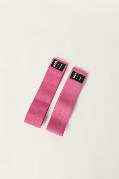 Pair of pink resistance bands with black brand labels