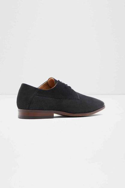 Black lace-up oxford shoes, side view, brown heel and visible tan lining