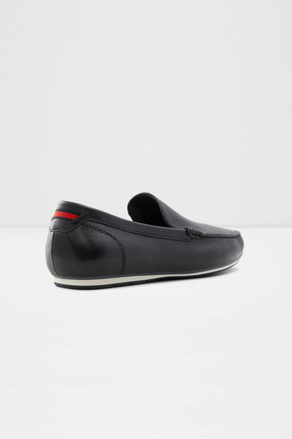 Dark leather slip-on loafer with red heel accent and low-profile sole