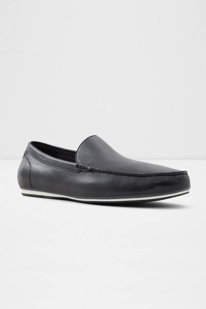 Dark leather slip-on loafer with low profile sole and moc-toe stitching