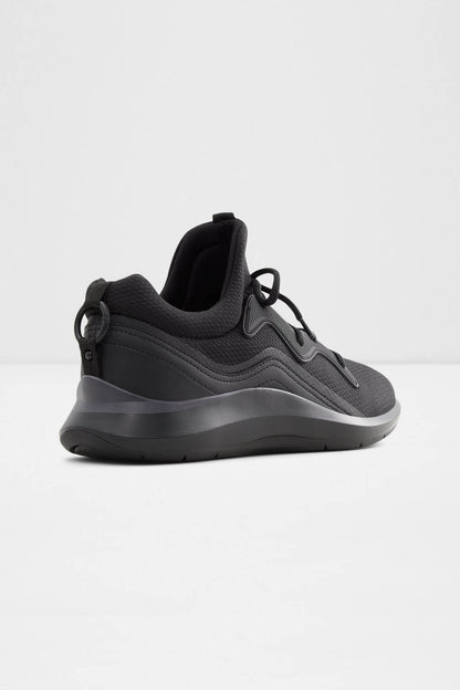 Black athletic sneakers, side view, gray sole edge and lace-up design