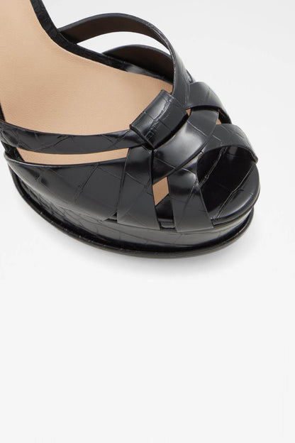 Black crisscross strap platform sandal close-up with glossy finish