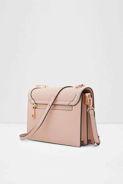ALDO light pink structured crossbody bag with front flap, gold chain strap, side tassels