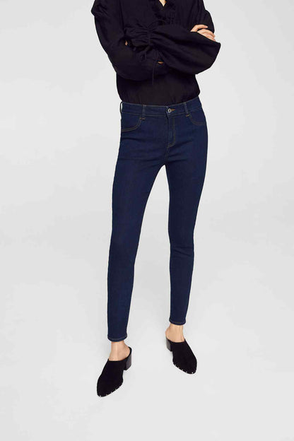 Dark blue slim-fit jeans with button-and-zip fly, belt loops, and skinny legs
