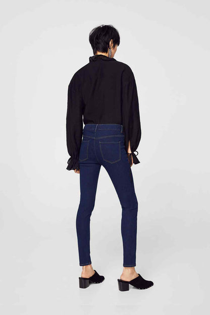 Dark blue slim-fit jeans viewed from back with belt loops and ankle-length skinny legs