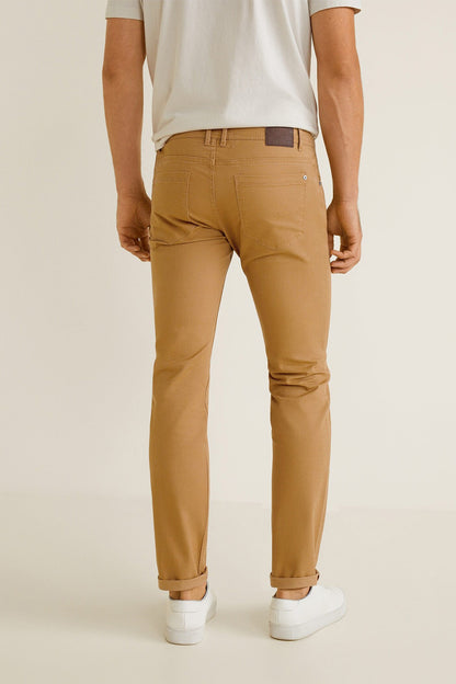 Tan chino pants with front pockets, belt loops, and cuffed hem