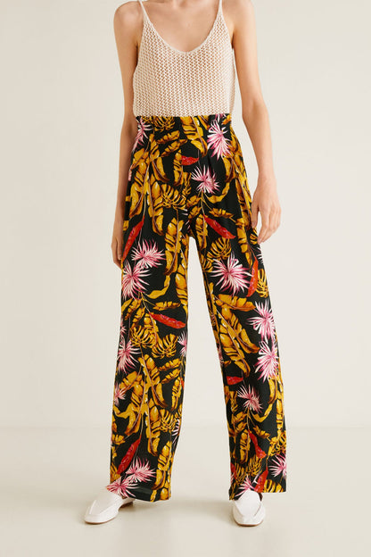 Sleeveless mesh camisole with wide-leg floral trousers, black base