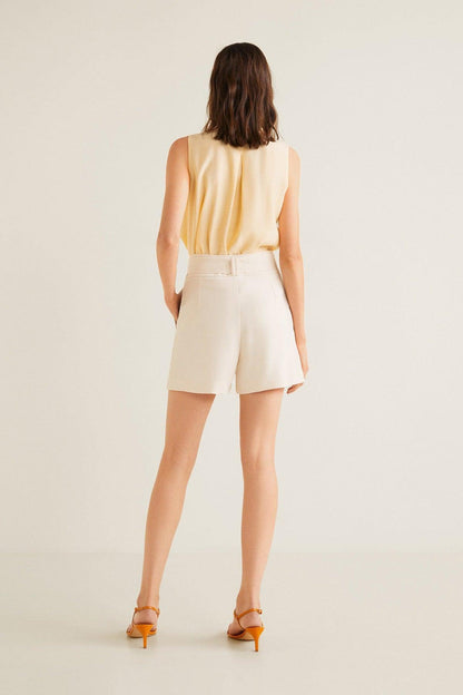 Back view of vanilla sleeveless blouse with belt and matching shorts