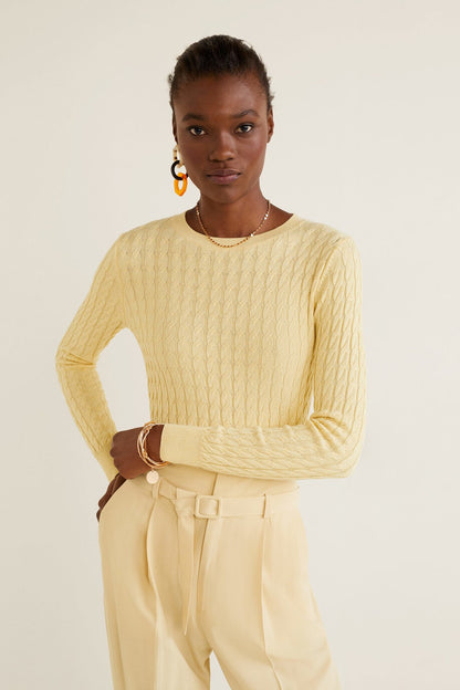 High-waist vanilla trousers with tie belt; knit sweater sleeve visible