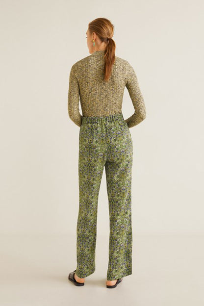 Back view of green patterned long-sleeve jumpsuit with high neck and wide-leg pants