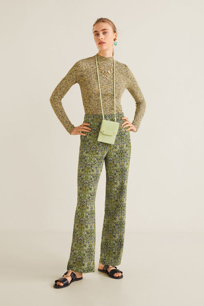 Green patterned long-sleeve jumpsuit with zip front, pockets, and wide-leg pants
