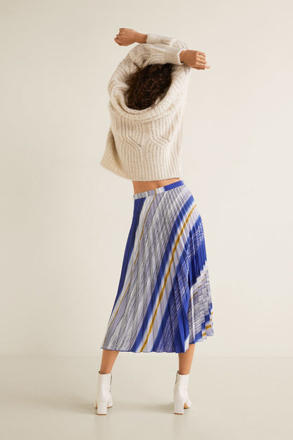 Cream cable-knit high-neck sweater with blue striped pleated midi skirt