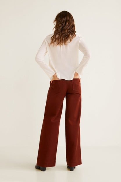Off-white long-sleeve blouse back and wide-leg rust trousers, rear view