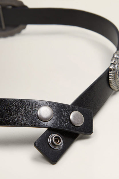 Black leather belt close-up with silver snap studs and overlapping strap end