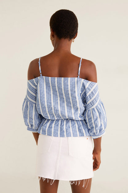 Blue-and-white striped off-shoulder blouse with puff sleeves, paired with white mini skirt