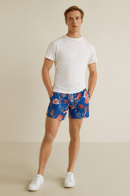 MANGO navy swim shorts with red marine print on male model, above-knee length