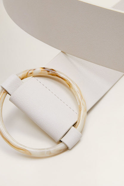 Off-white leather strap with stitched end and marbled round buckle loop