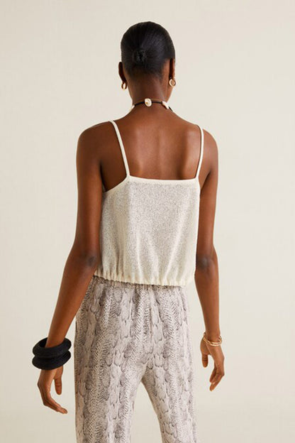 Back view of off-white camisole top with thin straps and snakeskin-print wide-leg pants