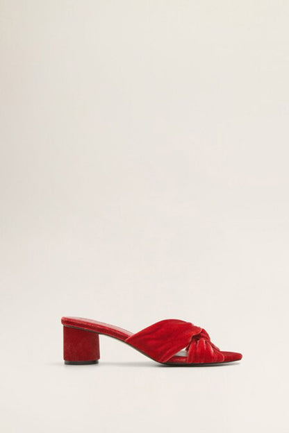 Red velvet heeled mule with open toe, twisted strap front, and block heel