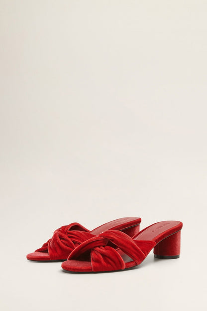 Red velvet heeled mules with open toe and twisted strap knot