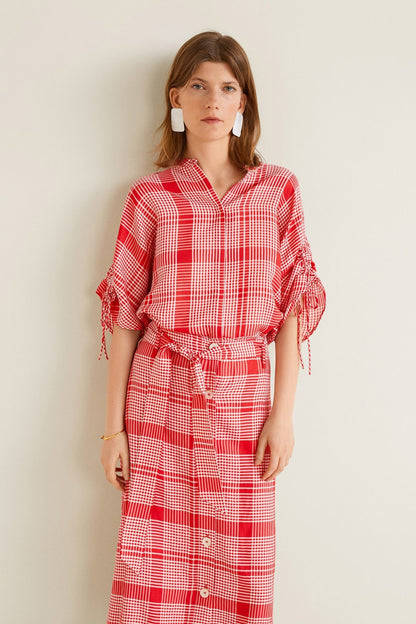 Red plaid shirt-style midi dress with button front, belted waist, tied sleeves
