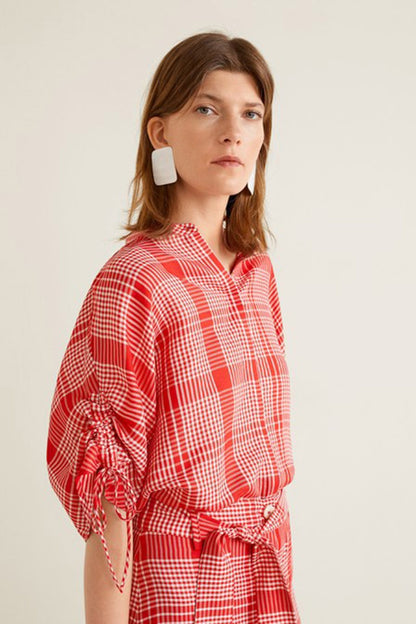 Red plaid shirt-style midi dress with button placket, belted waist, tied cuff