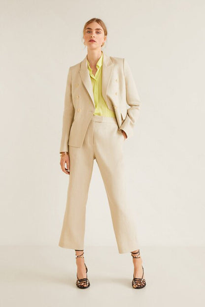 Lime sleeveless collared top with cream blazer and light beige wide-leg trousers