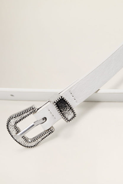 White belt buckle with silver frame and black stitched trim, close-up