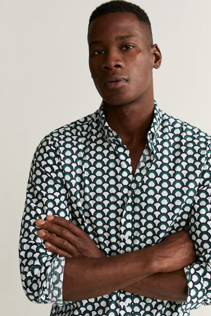 Mens patterned button-up shirt in teal and white circle print, close-up collar