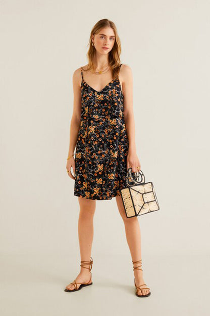Black floral slip dress with thin straps and straight hem, styled with sandals