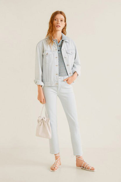 Light blue denim jacket over knit top with white slim jeans