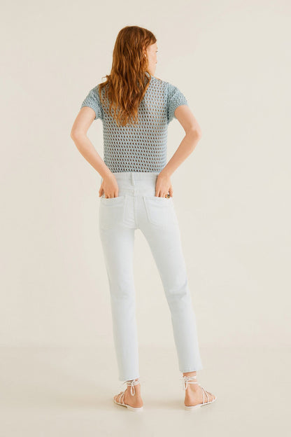 Bleach blue crochet-knit top with short sleeves and white slim jeans