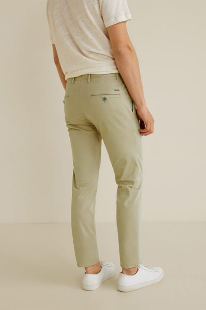 Beige slim-fit chino pants with belt loops, button fly, and slanted pockets