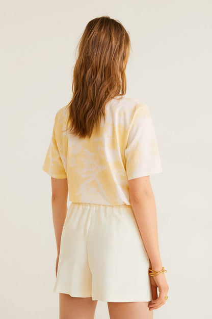 Off-white tie-dye short-sleeve top with elastic-waist shorts, back view