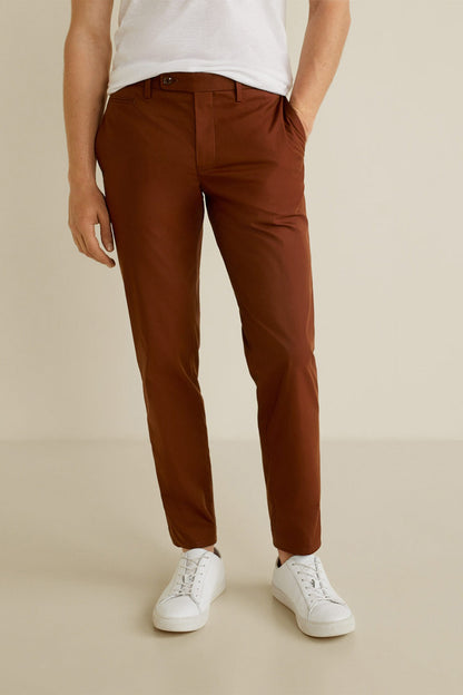 Brown chino-style trousers with belt loops, zip fly, and straight tapered legs