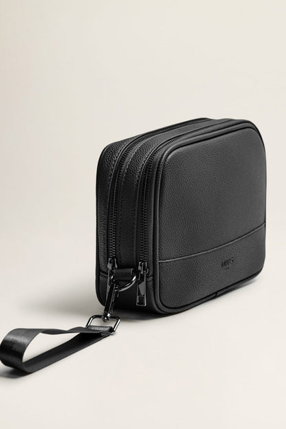 Black zippered crossbody bag with adjustable strap and logo patch