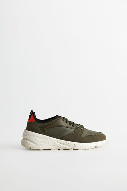 Khaki lace-up sneakers with chunky white sole and olive side panels