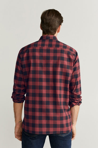 Back view of red and dark blue plaid button-up shirt with long sleeves