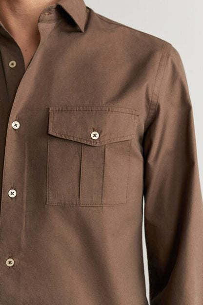 Brown shirt pocket detail with flap and button
