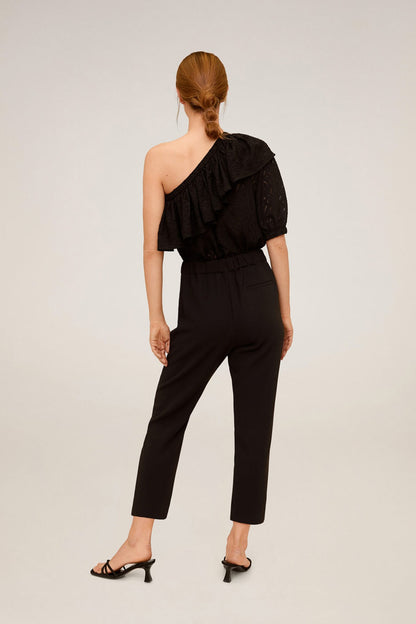 Black one-shoulder ruffled jumpsuit with tapered ankle pants, back view