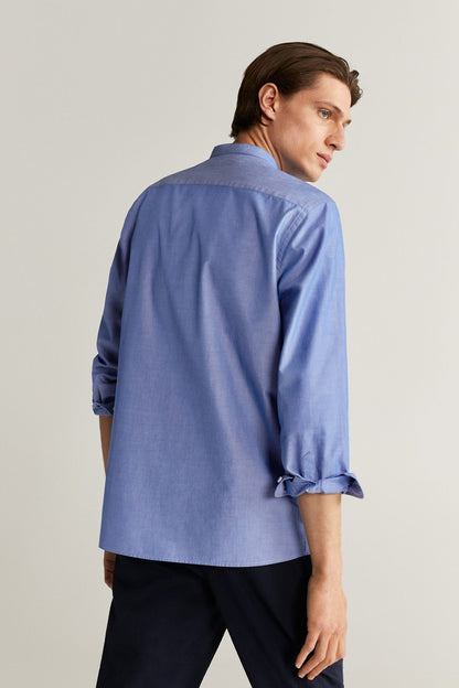 MANGO blue button-up shirt, back view with buttoned cuffs