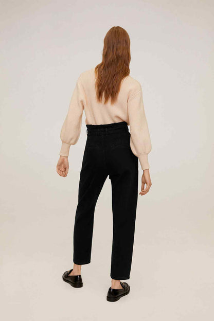 MANGO back view: beige knit sweater with black high-rise jeans