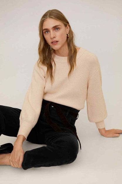 MANGO beige knit sweater with black high-rise jeans and waist tie belt